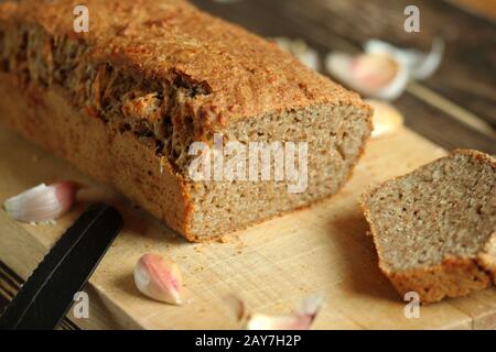 Delicate and crunchy bread. Gluten-free bread. Crunchy and tasty bread. Healthy bread. Bread with garlic and cheese. Tasty home-made bread. Stock Photo