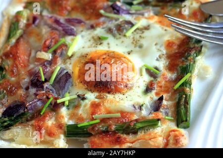 A delicious and tasty snack. Puff pastry with salmon, egg and asparagus . Stuffed puff pastry, quick snack. Delicious breakfast. Stock Photo