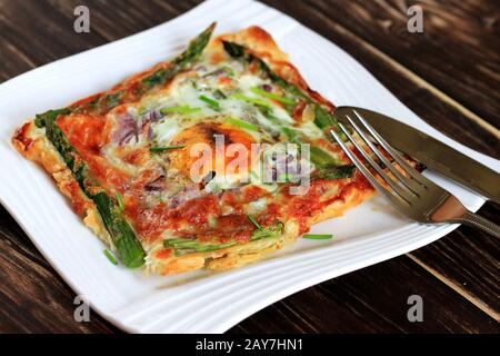 A delicious and tasty snack. Puff pastry with salmon, egg and asparagus . Stuffed puff pastry, quick snack. Delicious breakfast. Stock Photo