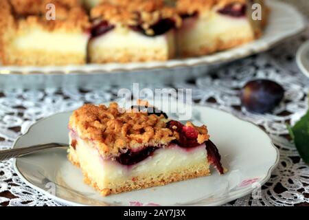 Cake with plums and custard. Homemade cake. Cake with fruit. A delicious and light dessert. Plum cake. Stock Photo