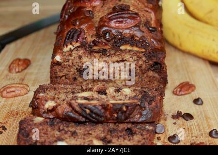 chocolate banana bread. Banana cake. Homemade chocolate cake with banana and nuts.  Pecan pie. Healthy sweets. Stock Photo