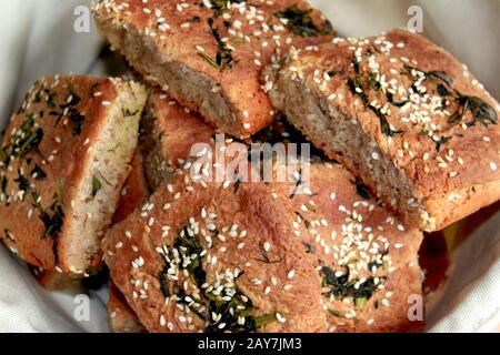 Homemade sesame buns. Rolls in a small basket. Whole wheat bread. Stock Photo