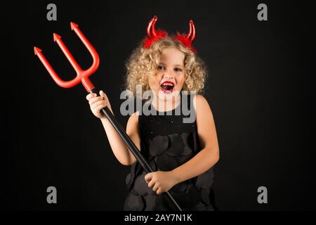 Cute girl in devil costume Stock Photo