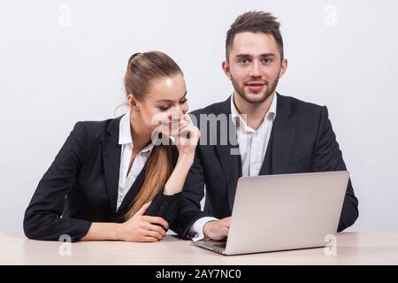 man and woman sitting in a business suit at a table in front of Stock Photo