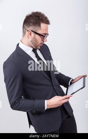 Creative young programmer in a business suit with a tie and sung Stock Photo