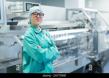 operator in the pharmaceutical factory near the equipment Stock Photo