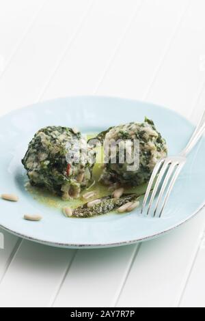 two Italian strangolapreti spinach dumplings Stock Photo