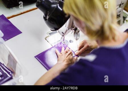 woman stitching a purse Stock Photo