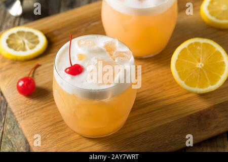 Refreshing Raki Vodka Sour Cocktail with a Cherry Stock Photo