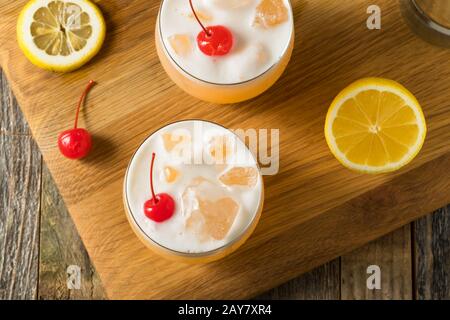 Refreshing Raki Vodka Sour Cocktail with a Cherry Stock Photo