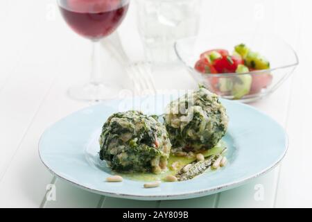 two Italian strangolapreti spinach dumplings Stock Photo