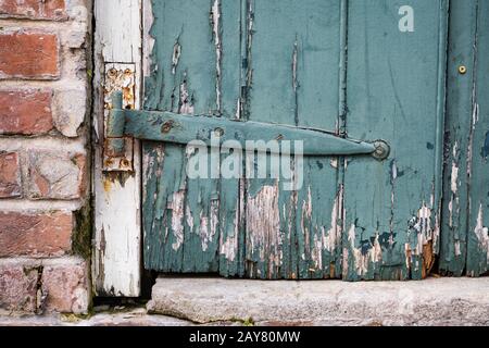 A rusty metal hinge on an old door in the French Quarter of New Orleans Stock Photo