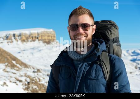 Portrait of a happy laughing Hipster traveler with a beard in sunglasses in the nature. Stock Photo