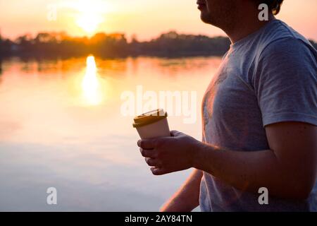 Man holding a bamboo cup with coffee Stock Photo