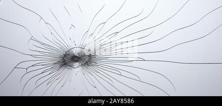 Broken glass. Lines and cracks on a gray background. Stock Photo