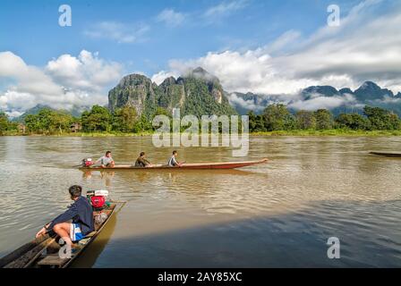 Vang Vieng / Laos -july 08 2005 : canoes to villages along the Nam Song river Stock Photo