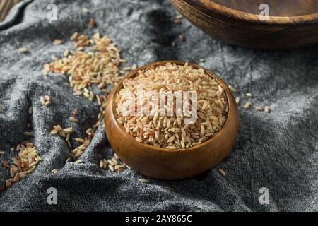 Raw Organic Volcano Brown Rice in a Bowl Stock Photo