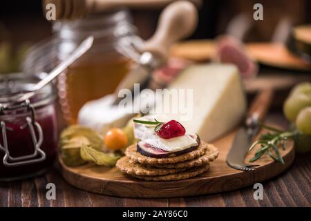 Cheese crackers with camembert,cranberry,fig and herb Stock Photo