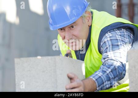 construction worker moving mixer in masonry site Stock Photo