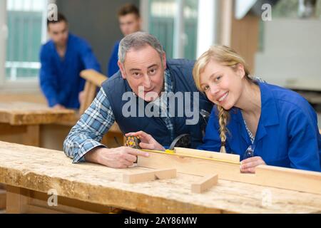 woman apprentice and man in workshop
