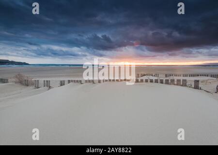 dramatic sunset and storm clouds over beach in Tarifa, Spain Stock Photo