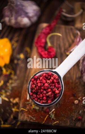 Red pepper whole seeds on spoon. Stock Photo