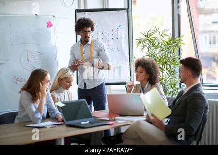 young afro-american woman asking a colleague at the business meeting. business, meeting, presentation, planning, discussion Stock Photo