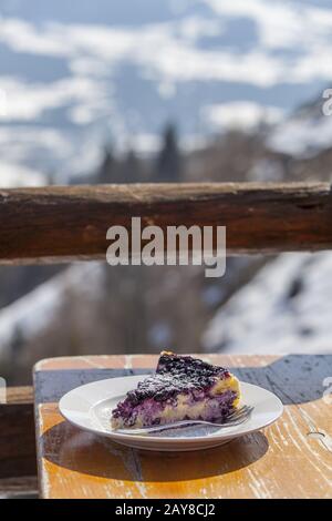 Blueberry cheesecake outdoors in the mountains Stock Photo