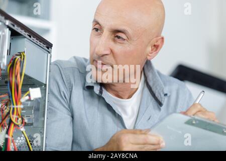 a male technician fixing pc cables Stock Photo