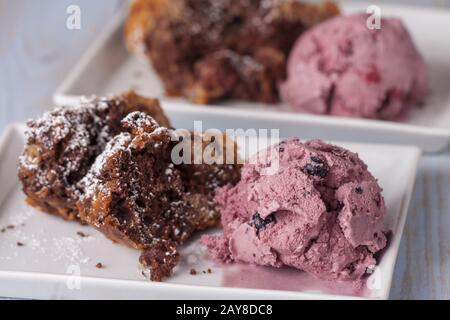 Marble cake and strawberry ice cream on plates Stock Photo