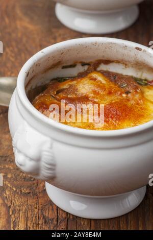 French onion soup with cheese on wood Stock Photo