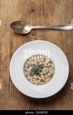 Bavarian Brätspätzle soup with the spoon on wood Stock Photo