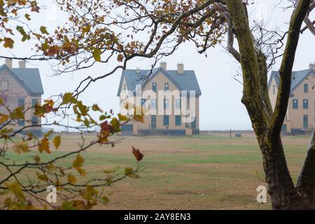 A view of the houses along Officers Row at Fort Hancock on a foggy autumn day. This is an inactive army military base on Sandy Hook, part of the Gatew Stock Photo