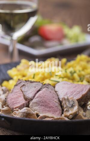 Swabian pork fillet with spaetzle and wine Stock Photo