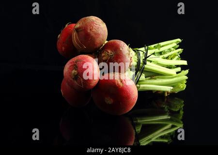 large bunch of fresh radish. Black background. Top view Stock Photo