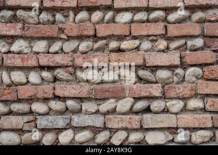 Pattern alternating with bricks and river stones - Background Stock Photo