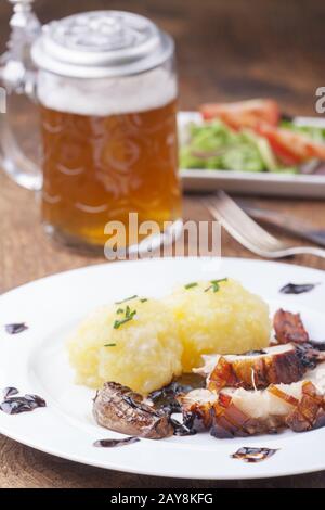 Bavarian roast pork with beer and dumplings Stock Photo