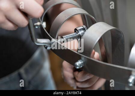 Craftsman works with tools and fixes screws and nuts - Detail Stock Photo