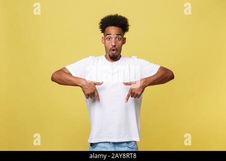 Astonished young African American man dressed in casual white shirt having excited fascinated look, pointing index finger at cop Stock Photo