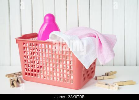 Terry towels and detergent in the laundry basket Stock Photo