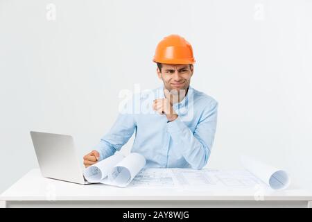 Serious man businessman or engineer sitting in construction site. Courageous middle aged man sit with sad,serious and depressed Stock Photo