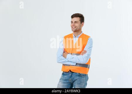 Visionary architect or engineer looking up and thinking about new projects. Wearing reflective vest isolated on white background Stock Photo