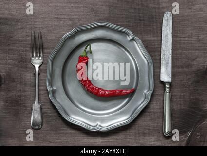 Red chilli pepper on pewter plate Stock Photo