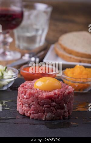 Steak tartar with an egg on slate Stock Photo