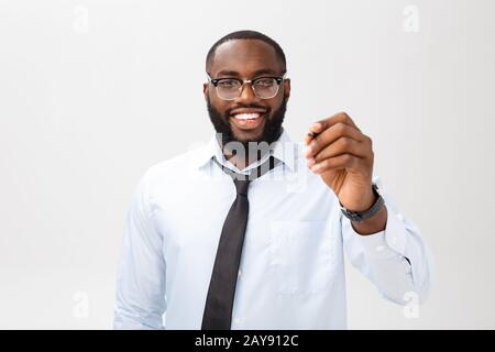 Young African american business man writing something on glass board with a marker Stock Photo