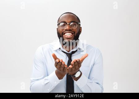 Closeup of young african american man isolated on gray background , putting hands together as if he is praying Stock Photo