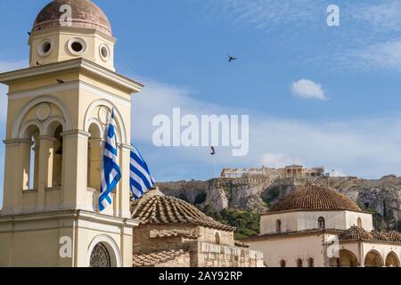 View of the Acropolis monument from Monastiraki Square as pigeons fly by Stock Photo
