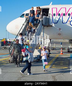 Passengers people leave airplane airport Stock Photo