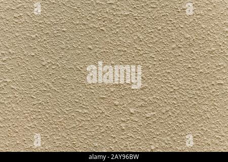 Bright beige rough plastered house wall as a background Stock Photo