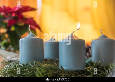 first candle on Advent wreath is burning - atmospheric candlelight Stock Photo